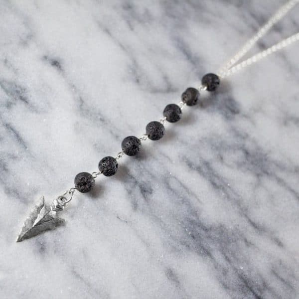 Volcanic stone arrow sweater necklace